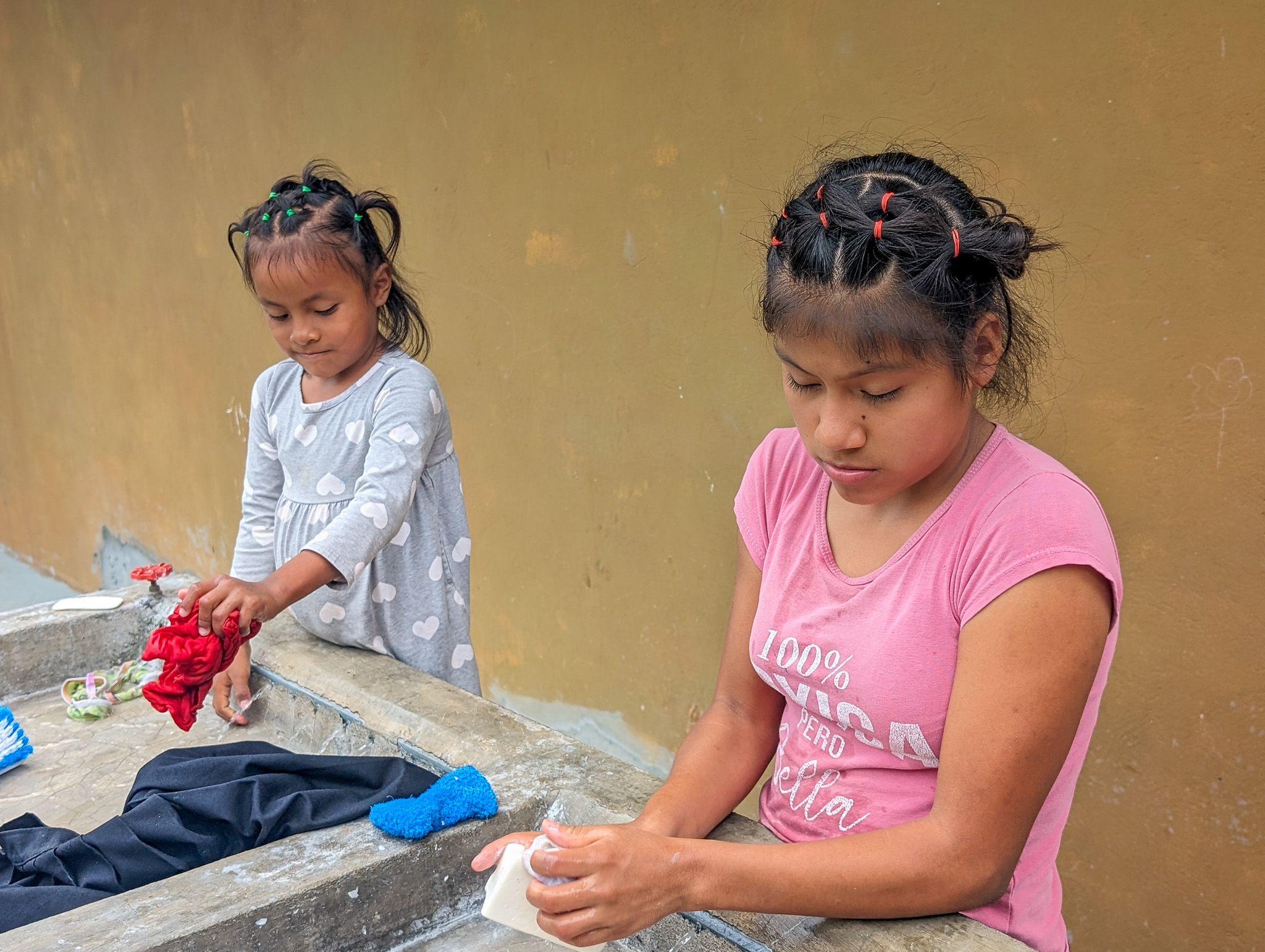 children washing clothes